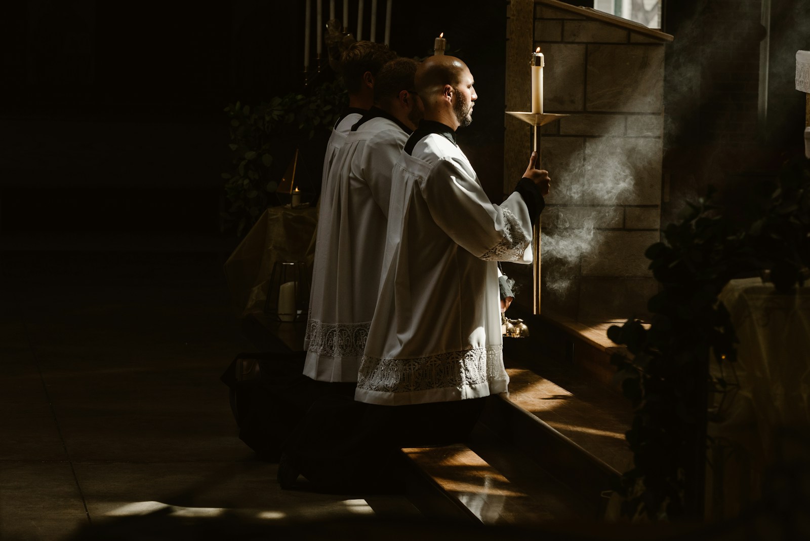 Church leaders kneeling in prayer during a liturgical service