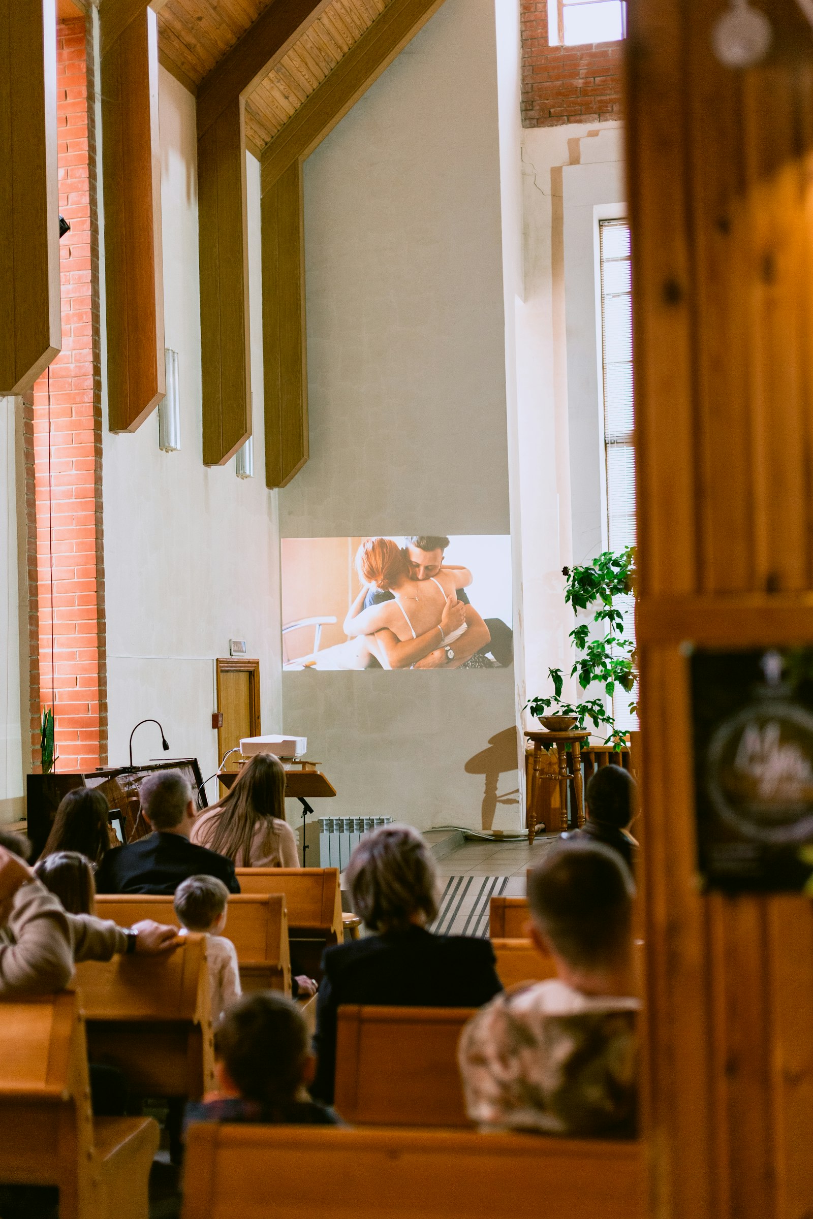 Visitors seated in pews during a church service